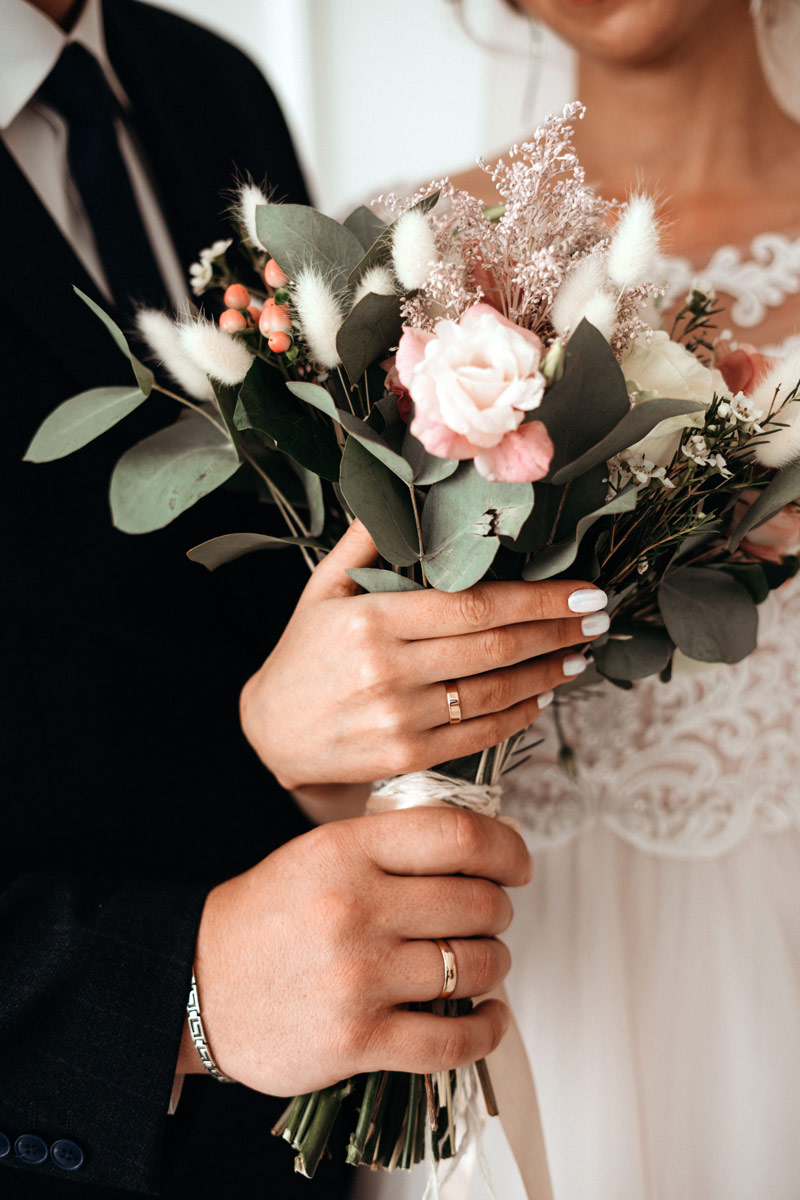 bride groom holding flowers wedding